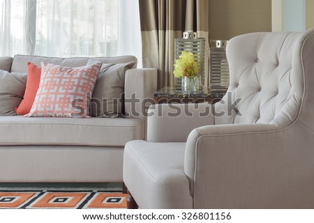 Comfy beige arm char with chinese style in orange theme living corner