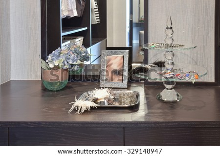 female accessories on wooden dressing table at home