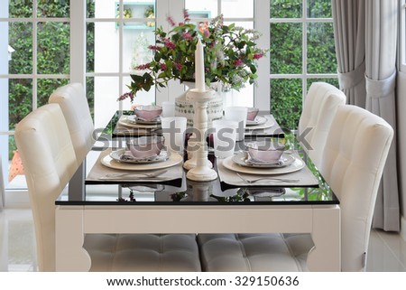 dining table and comfortable chairs in vintage style with elegant table setting