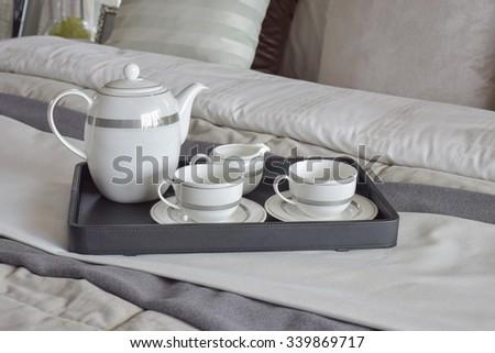 elegant tea cup set on black tray in modern bedroom interior