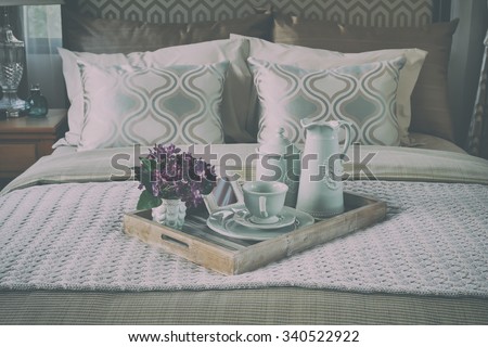 wood tray of tea cup set on bed in bedroom interior with vintage style effect