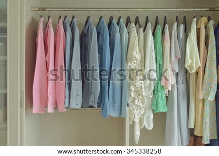 Women cloths hanging in wooden wardrobe