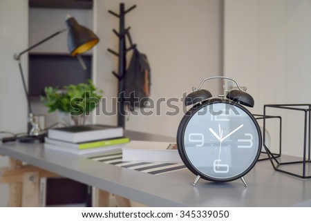black alarm clock on work table at home