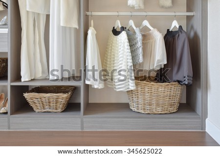 modern closet with row of white dress and shoes hanging in wardrobe