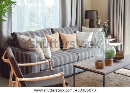 modern living room interior with striped pillows on a casual sofa at home