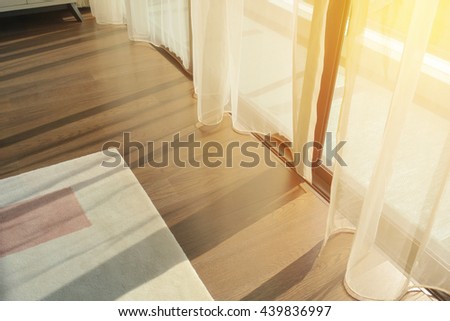sunrise through transparent curtains of a window in the morning