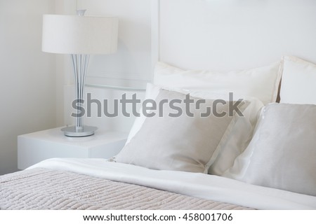 Light gray pillow setting on bed in nice vibe bedroom modern interior style