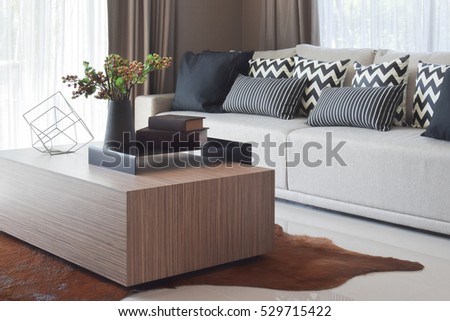 stylish living room design with grey striped pillows on comfortable sofa