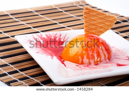 Dessert with peach, cracker and cream, on white plate