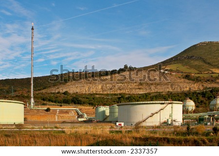 The chimney and storage tanks of a oil refinery