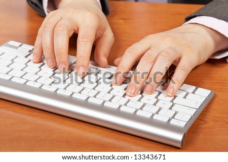 Businesswoman typing on computer keyboard. Shallow depth of field