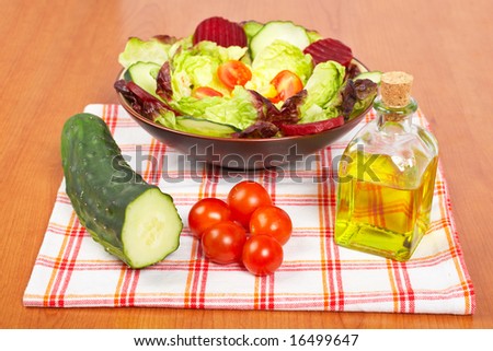 Mediterranean salad with lettuce tomatoes cucumber oil and beet. Shallow depth of field