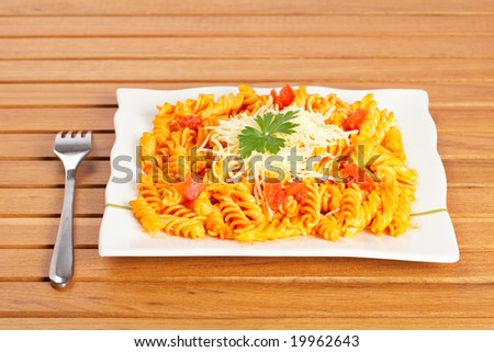 Freshly cooked plate of fusilli pasta with tomato sauce just for eating. Shallow depth of field