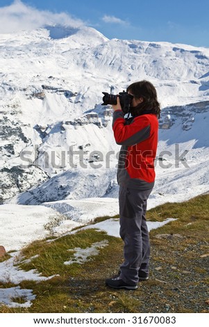 Woman photographer in Grossglockner, National Park Hohe Tauern, Austria