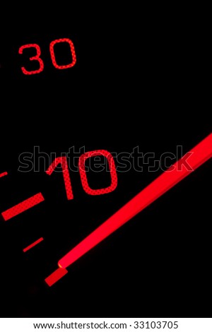 Orange neon speedometer over a black background