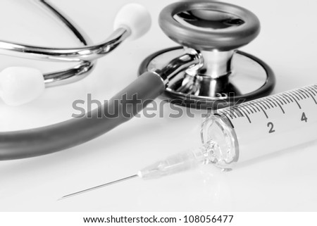 Stethoscope with syringe on white background Stethoscope with syringe on white background