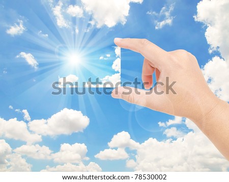 Hand holding the sky in the clear blue sky