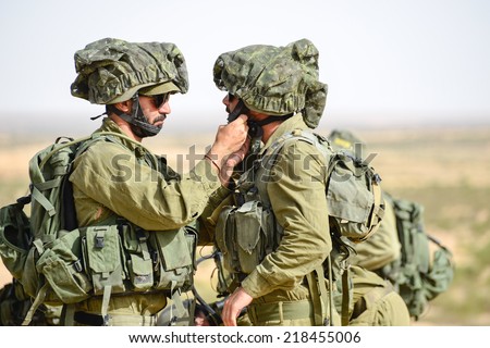 Gaza Strip/Israel -July 12th - Israeli soldiers help each other in July 12th 2014 in the fields around Gaza Strip during their army service.