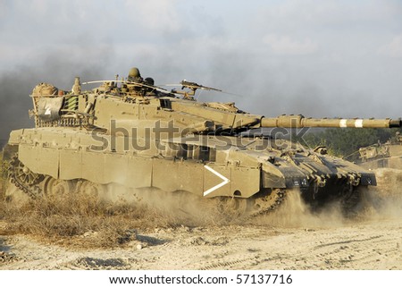 An Israeli tank doing maneuver in open fields and urban area, this is part of regular army training in Israel for regular and reserve soldiers.