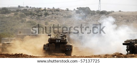 An Israeli tank doing maneuver in open fields and urban area, this is part of regular army training in Israel for regular and reserve soldiers.