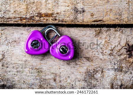 purple padlock  on wood  background