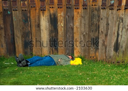 man sleeping near wooden wall