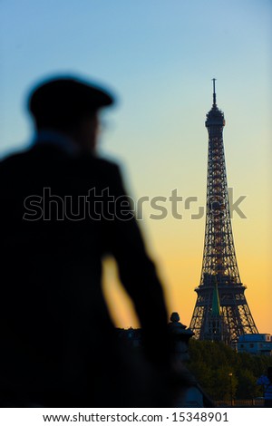 The famous landmark, Eiffel tower of Paris, France. A man\'s silhouette in the foreground.