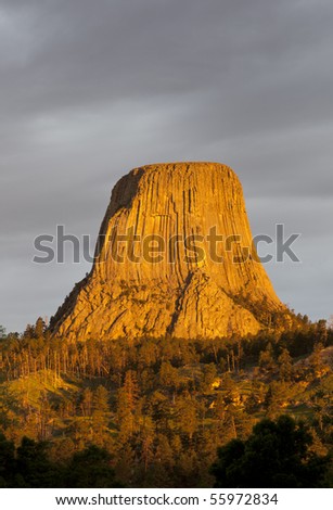 Devils Tower with a golden glow in the first sunlight, Devils Tower National Monument, Crook County, Wyoming, USA