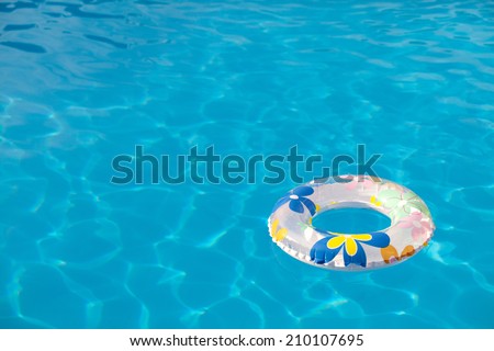 Background summer pool image shot. Buoy floating on the pool water.
