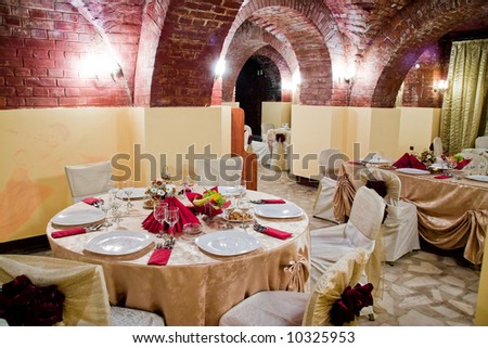 stock photo Fancy table set for a wedding dinner in ancient brick wall