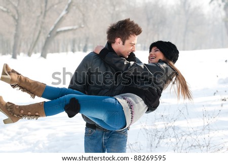 young couple having fun in the park, in winter holidays