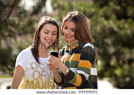 two young women looking at the phone