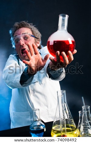 Mad Scientist extending explosive concoction away from his face