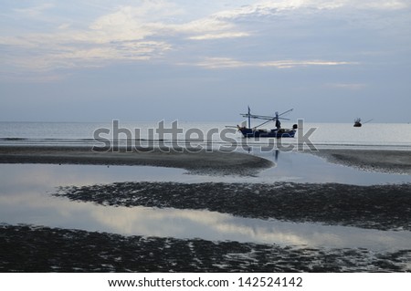 Morning Scene of Fishing Boats, Calm Sea and S-curve waterways on the beach in Prachuabkirikan, Thailand