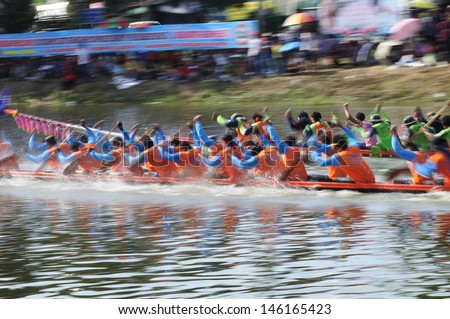 PRATUMTHANI, THAILAND - OCT 28: Panning shot of two rowing teams in full speed during Thai Boat Competition for Royal Championship Cup on October 28, 2012 in Rangsit, Prathumthani,Thailand.