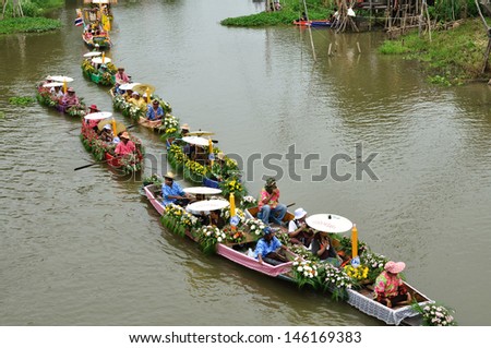 AYUTTHAYA, THAILAND - JULY 26: Top view of beautiful flower boats in floating parade, the unique annual candle festival of Buddhist lent on July 26, 2010 in Ladchado, Ayutthaya, Thailand