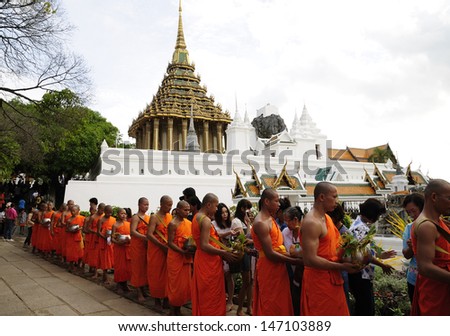 SARABURI, THAILAND-JULY 23: Unidentified people offer flowers to unidentified monks in the row on background of Phrabuddhabat temple on July 23, 2013 in Saraburi, Thailand.