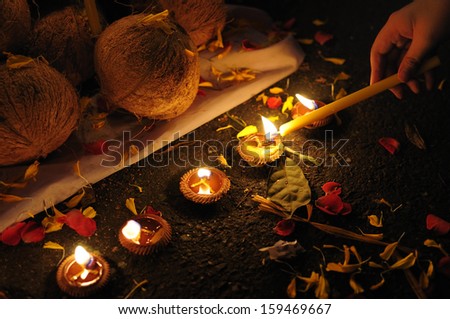 Candle light and rose petals with hand lighting a candle