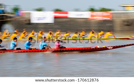 PATHUMTHANI, THAILAND - NOV 03: Panning shot of two rowing teams in full speed during Thai Long-tailed Boat Competition along river on November 03, 2013 in Samkhok, Pathumthani, Thailand.