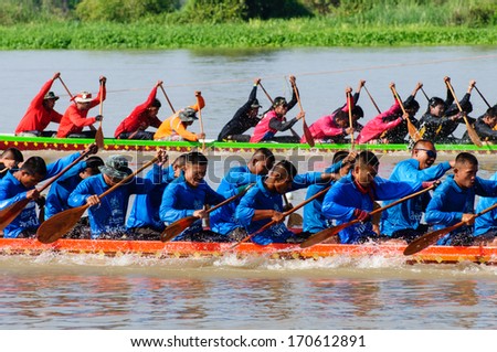 PATHUMTHANI, THAILAND - NOV 03: Two rowing teams in full speed during Thai Long-tailed Boat Competition along river on November 03, 2013 in Samkhok, Pathumthani, Thailand.