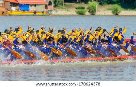 PATHUMTHANI, THAILAND - NOV 03: Two rowing teams in full speed during Thai Long-tailed Boat Competition along river on November 03, 2013 in Samkhok, Pathumthani, Thailand.