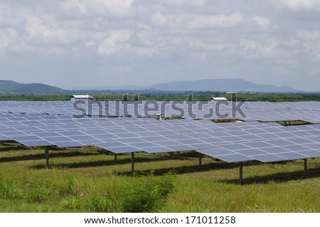 Solar panels in green field - wide shot