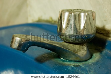 Old Dirty Never been cleaned Water Tap attached to blue ceramic sink