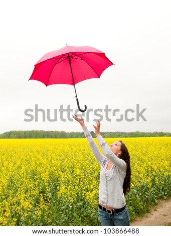 Young woman with umbrella in the wind