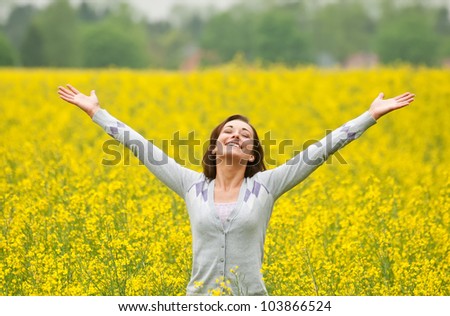 Young woman cheering in the field