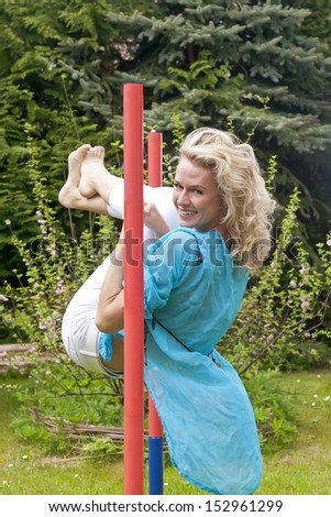cheerful young woman on the high bar