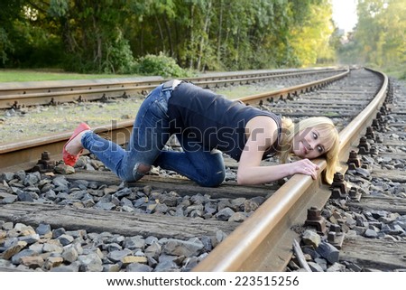 beautiful young woman listening to rail track
