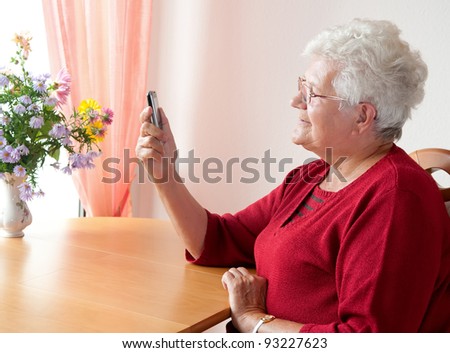 old woman reading a sms