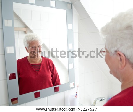cheerful pensioner looking in the mirror