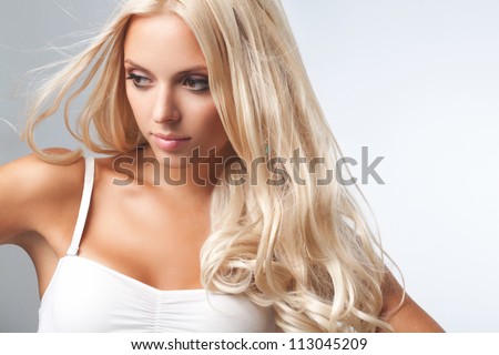 Portrait of beautiful blonde woman . Healthy Long Blond Hair. Hair Extension